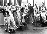 George Harrison chanting Hare Krishna with devotees in London.