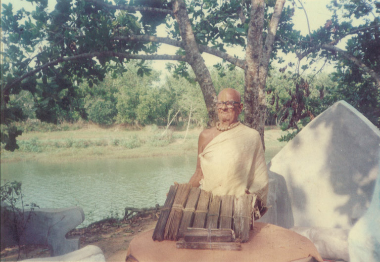 Srila Haridas Sen Babaji Maharaja posing with all his ancient literary possessions. (The old palm leaf writings, which also includes the original Sri Caitanya-caritamrta.)